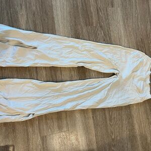 Tan flare yoga pants with cross top band and slit bottoms